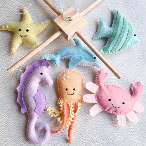 Rainbow under the sea theme mobile on a wooden frame