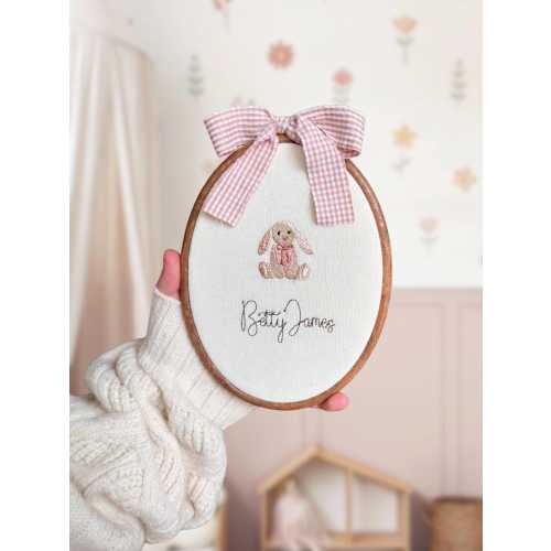 Embroidered oval baby name sign with a bunny and floral wreath | baby name announcement and nursery shelf decor