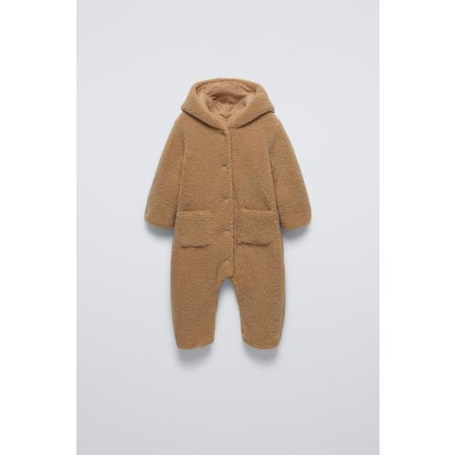 Faux shearling bodysuit with hood and long sleeves. Snap button closure and front patch pockets.Interior lining. - taupe brown | ZARA United States