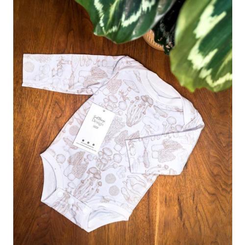 Handmade, neutral mushroom bodysuit for infants made with US sourced fabric with a variety of mushrooms