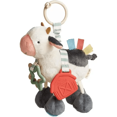 Itzy Ritzy Link & Love Toy for Stroller or Car Seat; Features Textured Ribbons, Crinkle Sounds, Clinking Rings & Silicone Teether; Designed for Ages 0 Months and Up (Cow)