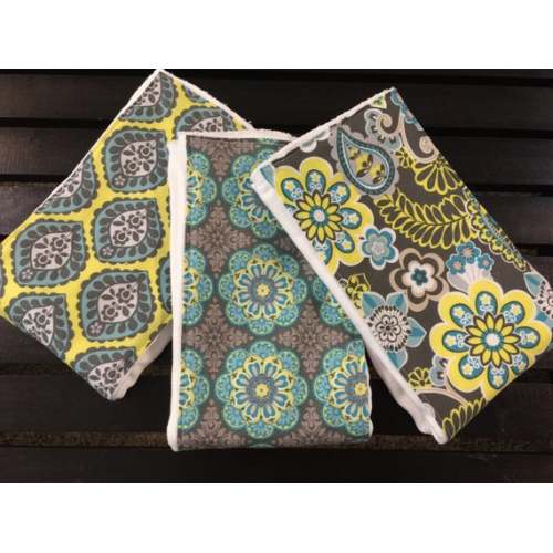 Boho baby girl burp cloths in turquoise, gray, and yellow flowers on Oso Cozy diapers