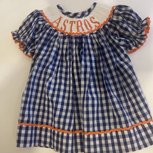 Hand Smocked Astro Dress! The bright blue and orange will make your little one shine bright! H-Town is showing their pride!