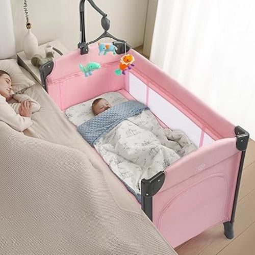 JOYMOR Baby Bedside Bassinet, Baby Bassinet, Pack n Play Convert Playpen, Quick Foldable Travel Bed with Toy, Wheels & Brake, Carry Bag for Boys Girls (Pink)