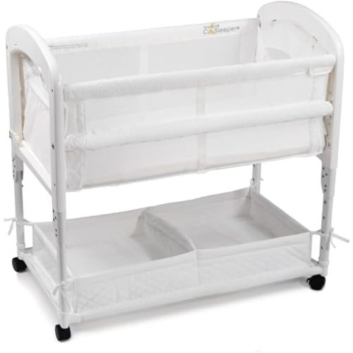 Arm’s Reach Cambria Co-Sleeper Bedside Bassinet Featuring Height-Adjustable Legs, Curved Wooden Ends, Breathable Mesh Sides with Pockets, and Large Lower Storage Basket, White