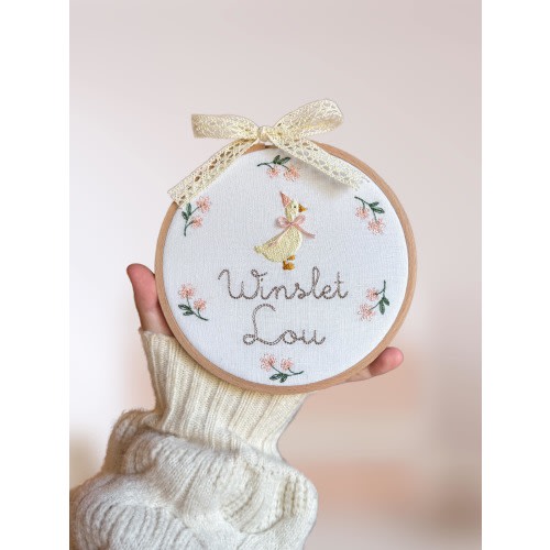 Embroidered plaque with baby’s name, nursery rhyme goose and a minimalist floral wreath | baby name announcement sign and nursery wall decor