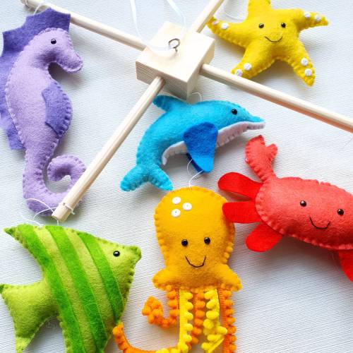 Rainbow under the sea theme mobile on a wooden frame