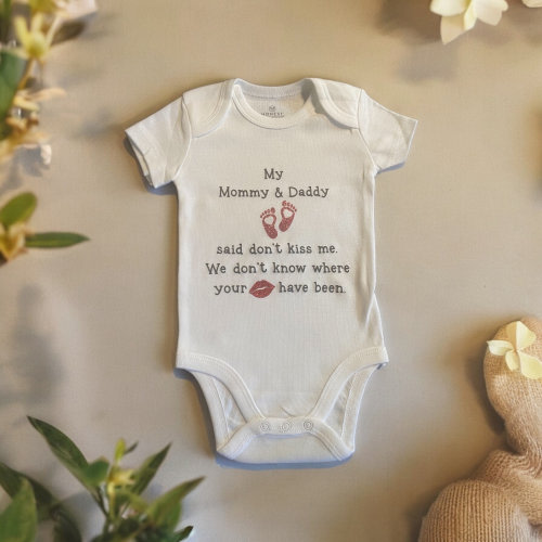 My Mommy & Daddy said don't kiss me. We don't know where your lips have been baby onesie. Custom name on bottom of onesie.