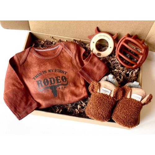 Cowboy First Rodeo Hand Dyed Rust Onesie Shower Gift Western Themed Nursery Gift with Rust Ball and Cow Teether Baby Moccasins Gift Box