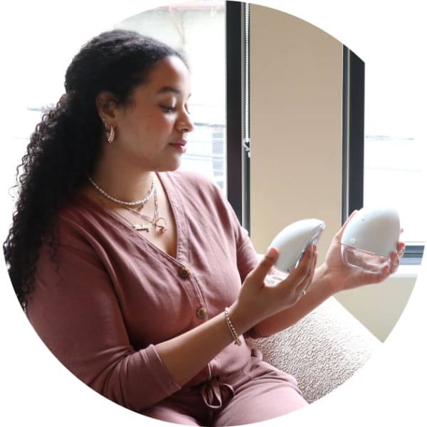 parent holding breast pump