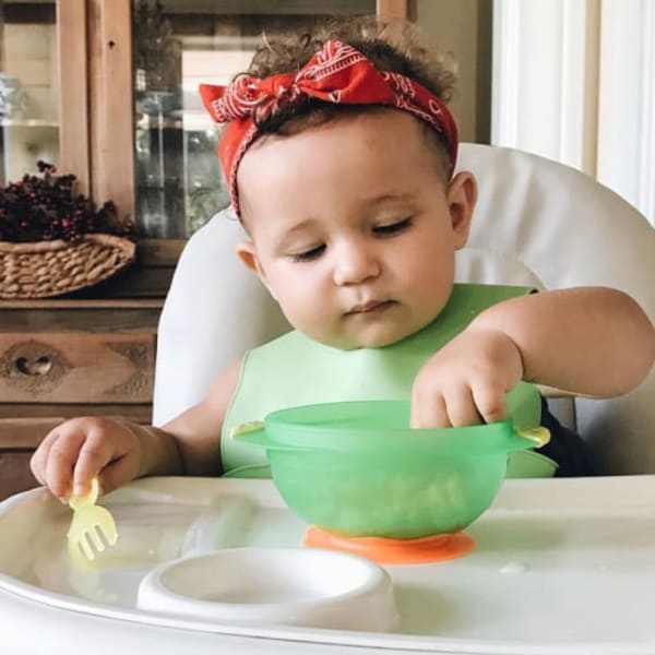 baby eating with bib