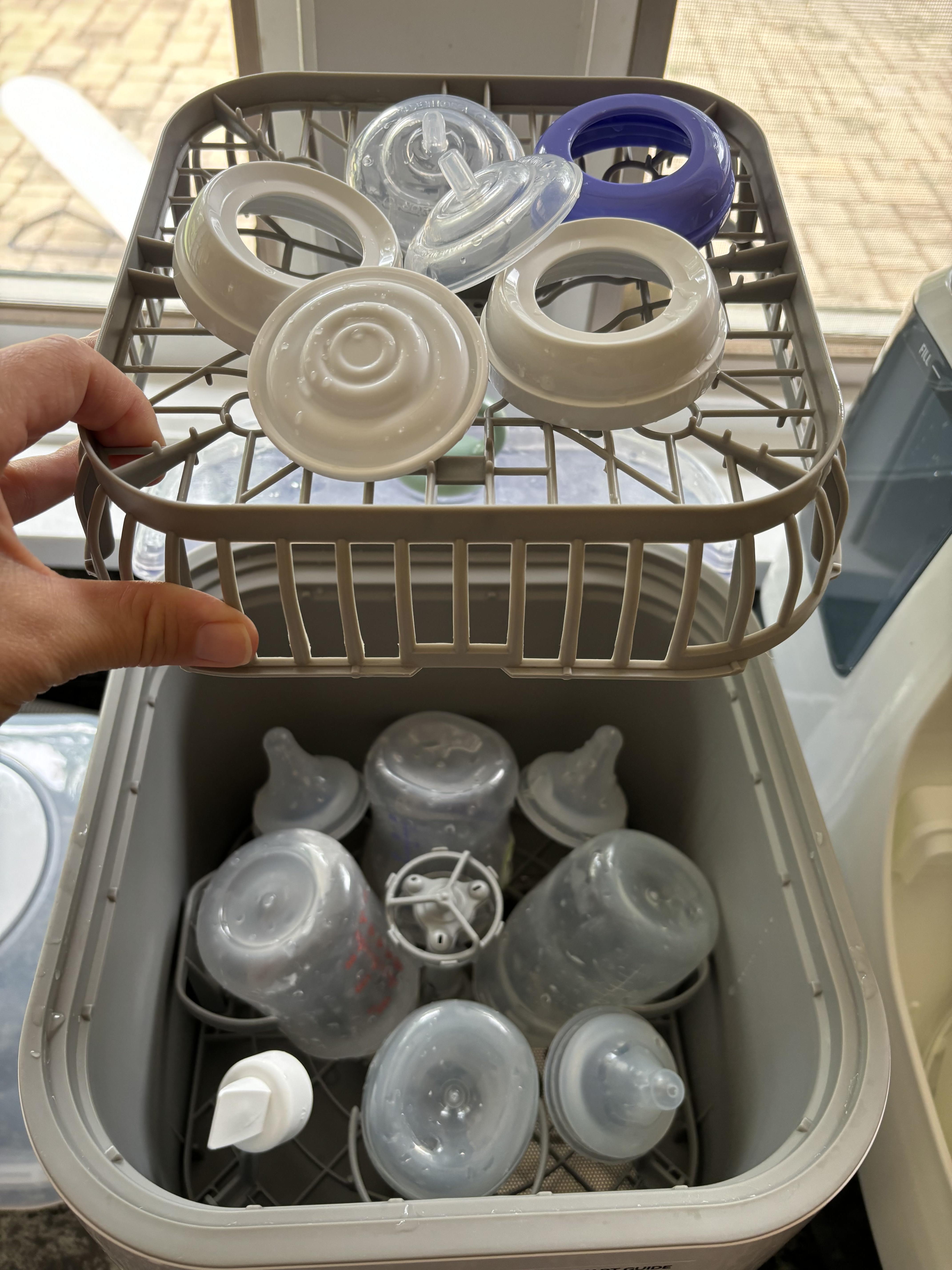 Baby bottle parts in Momcozy Bottle Washer.
