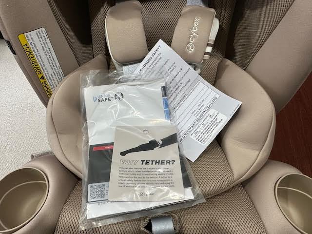 In most child restraint systems, you’ll find the manual and registration card right on top of the seat, as shown here on the Cybex Callisto G 360.