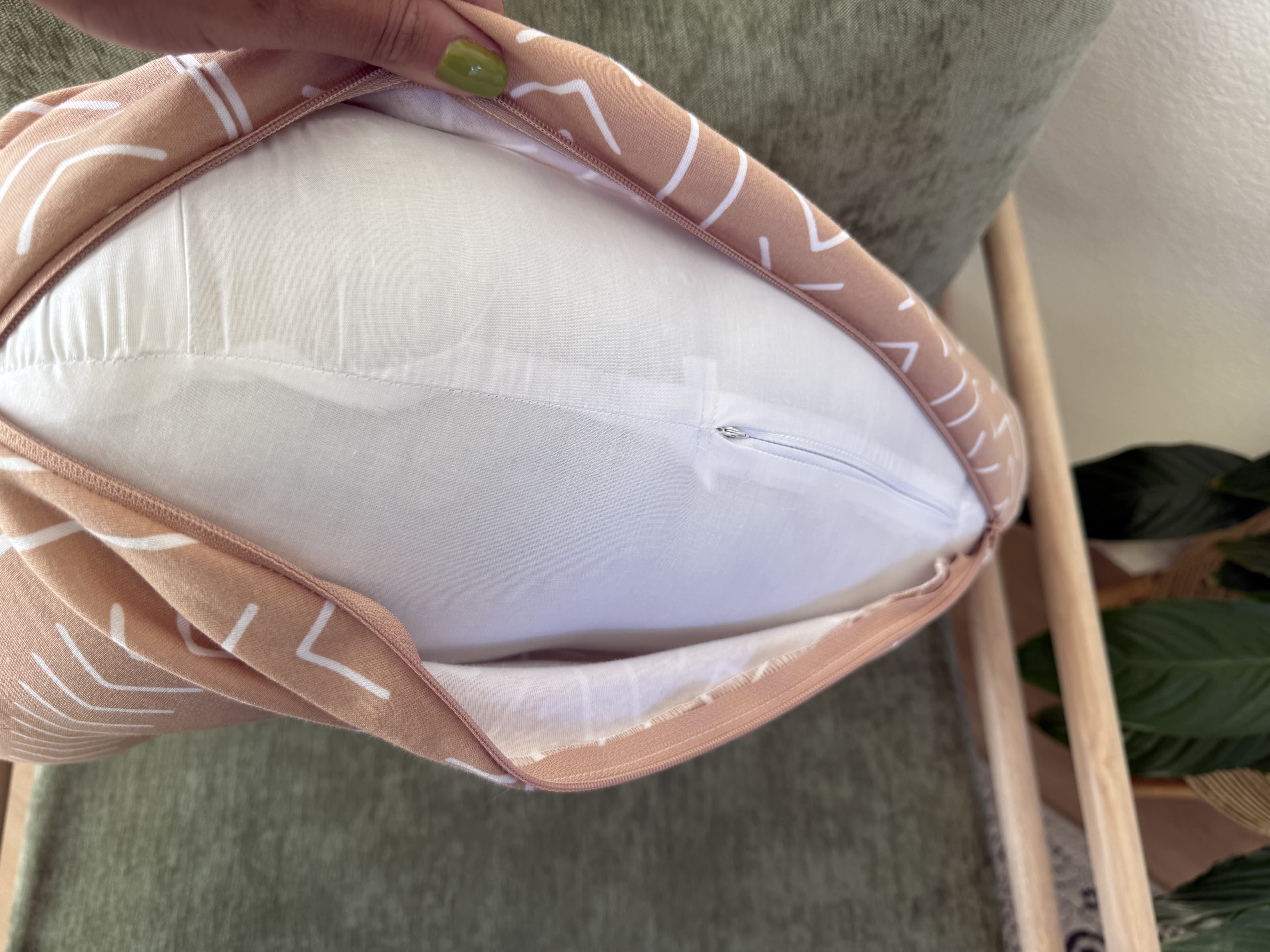Boppy nursing pillow with cover unzipped to show the insert.