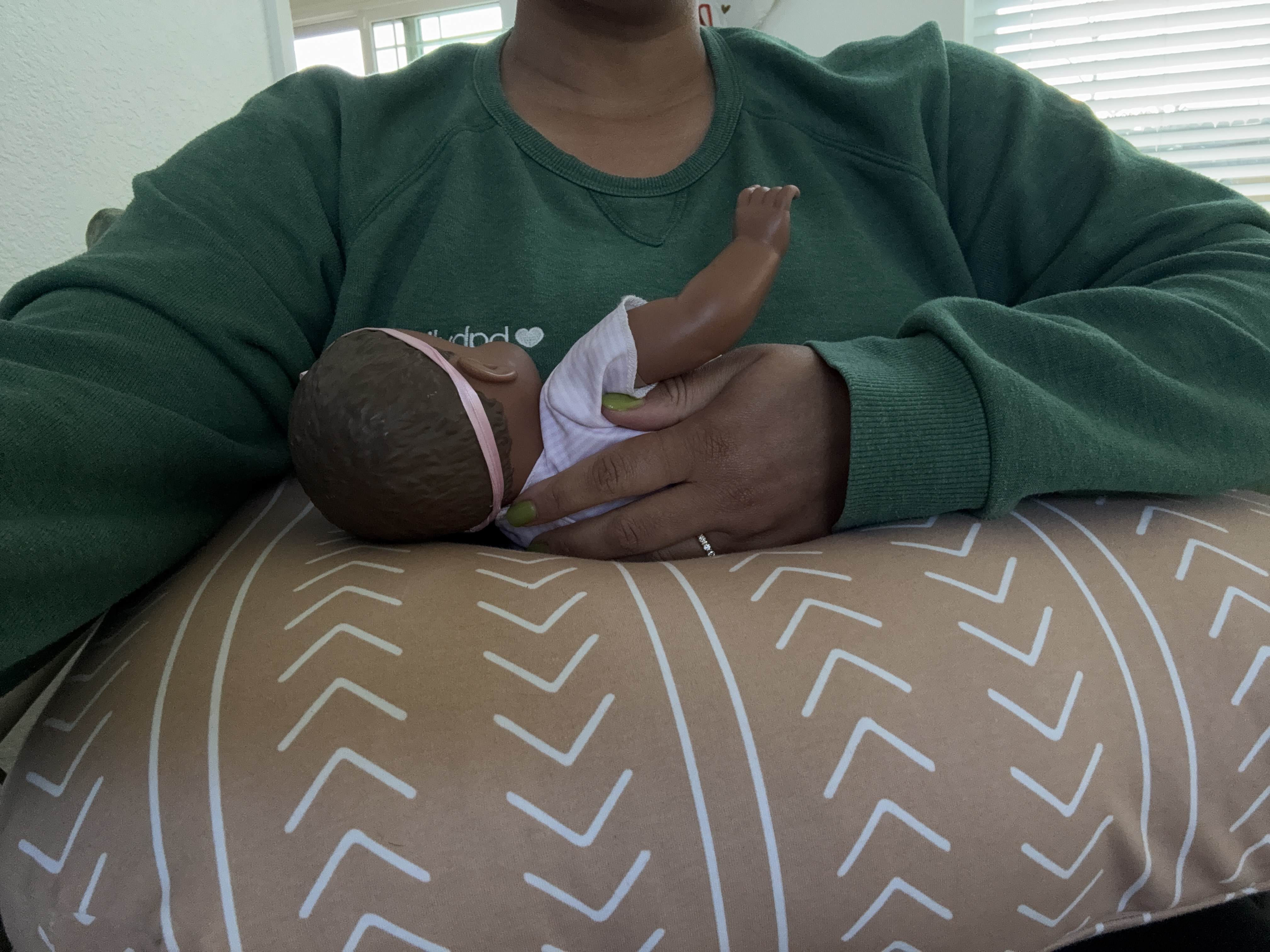 Demonstrating the Boppy with a doll.