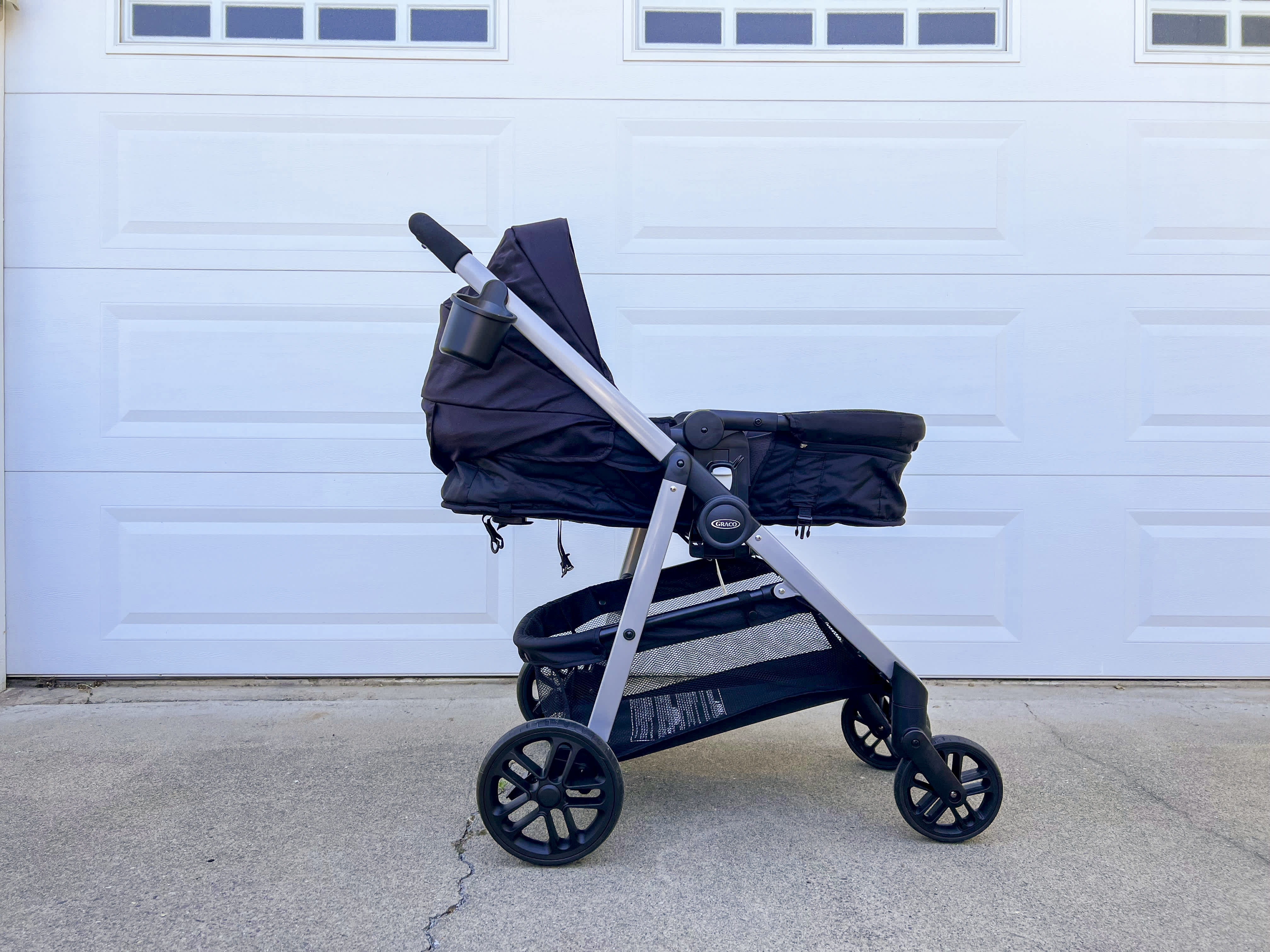 Side view of the Graco Modes pramette stroller in black in bassinet mode.