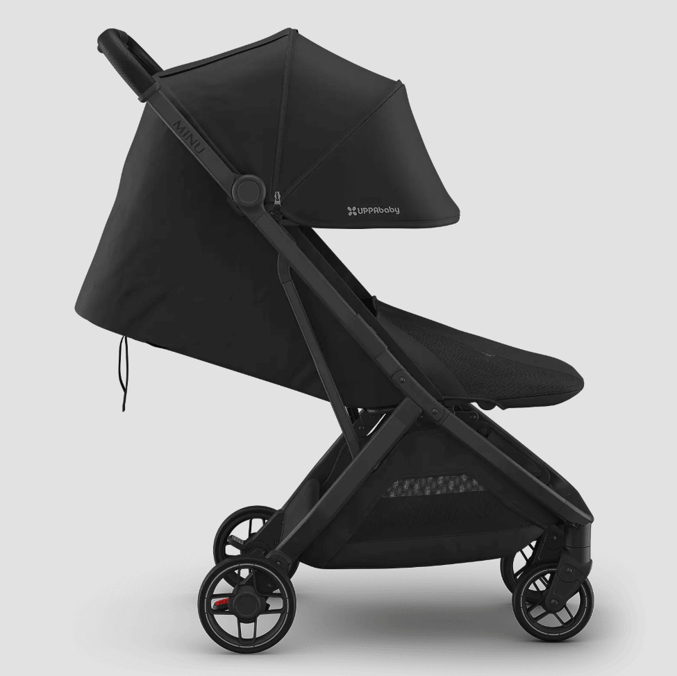 Side view of a black UPPAbaby Minu V3 stroller with the seat reclined nearly flat.