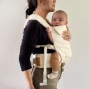 Side view of parent wearing baby in the Wildbird Aerial Carrier thumbnail.