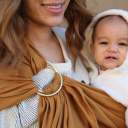 Close up image of parent wearing their baby in a Wildbird ring sling thumbnail.