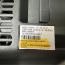 Close-up of a white date of manufacture label on a black car seat shell showing important safety details, including the date of manufacture, expiration date, model name, and number. thumbnail.