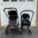 Head-on shot of an UPPAbaby Vista stroller next to a Doona. thumbnail.