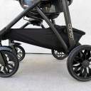 A side shot of the oversized black wheels on the Chicco Corso LE Modular Travel System stroller. thumbnail.