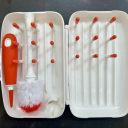 Top view of the white and orange Oxo Tot On-The-Go Drying Rack & Bottle Brush. thumbnail.