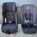A head on shot of two convertible car seats, both with black fabric: the Clek Foonf and the Diono Radian 3R. thumbnail.