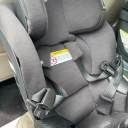 The harness straps of the Chicco Fit360 car seat being held open by the seat's magnetic buckle holders on either side. thumbnail.