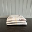 Stack of 3 Kirkland diapers on a black counter thumbnail.