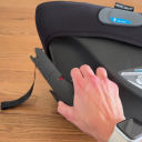 A white hand flipping the rigid LATCH connectors up and down on the Joie Mint Latch Baseless Infant Car Seat. thumbnail.