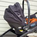 Two hands move the seat on the Joie Ginger and Mint Latch Travel System up and down thumbnail.